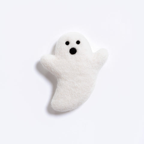 A small white felt ghost toy with black eyes and mouth, photographed on a clean white background.