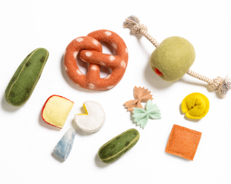 Collection of felt food toys on a white background